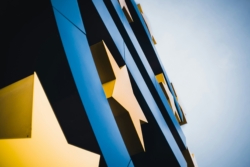 Close-up view of the large blue euro sign sculpture in Brussels, located on Willy-Brandt-Platz, featuring the iconic 12 yellow stars of the European Union.