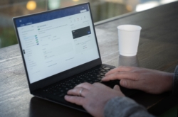 Close-up of a person’s hands using a laptop displaying how to list accounts within Fire’s API documentation. The screen shows a list of account settings and developer tools, suggesting API integration and account configuration.
