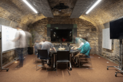 Colleagues collaborating in a modern office setting, illustrating how payment solutions for logistics companies streamline operations, reduce administrative workload, and enable just-in-time financial workflows.