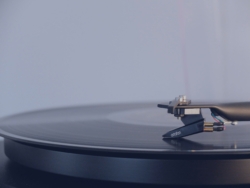 Close-up of a record player with a vinyl record spinning on the turntable.