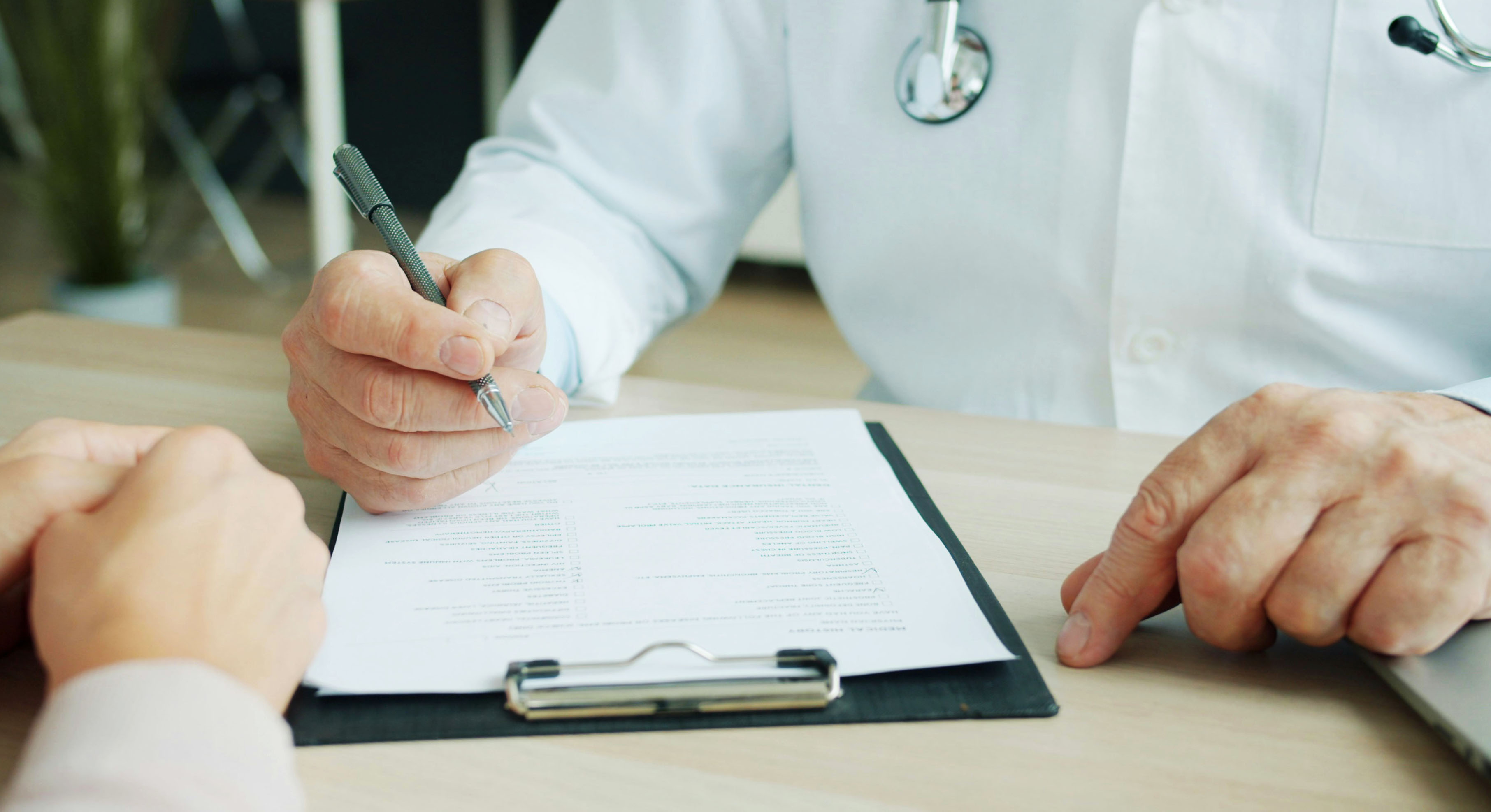 Doctor reviewing manual paperwork for healthcare payments and administrative tasks.