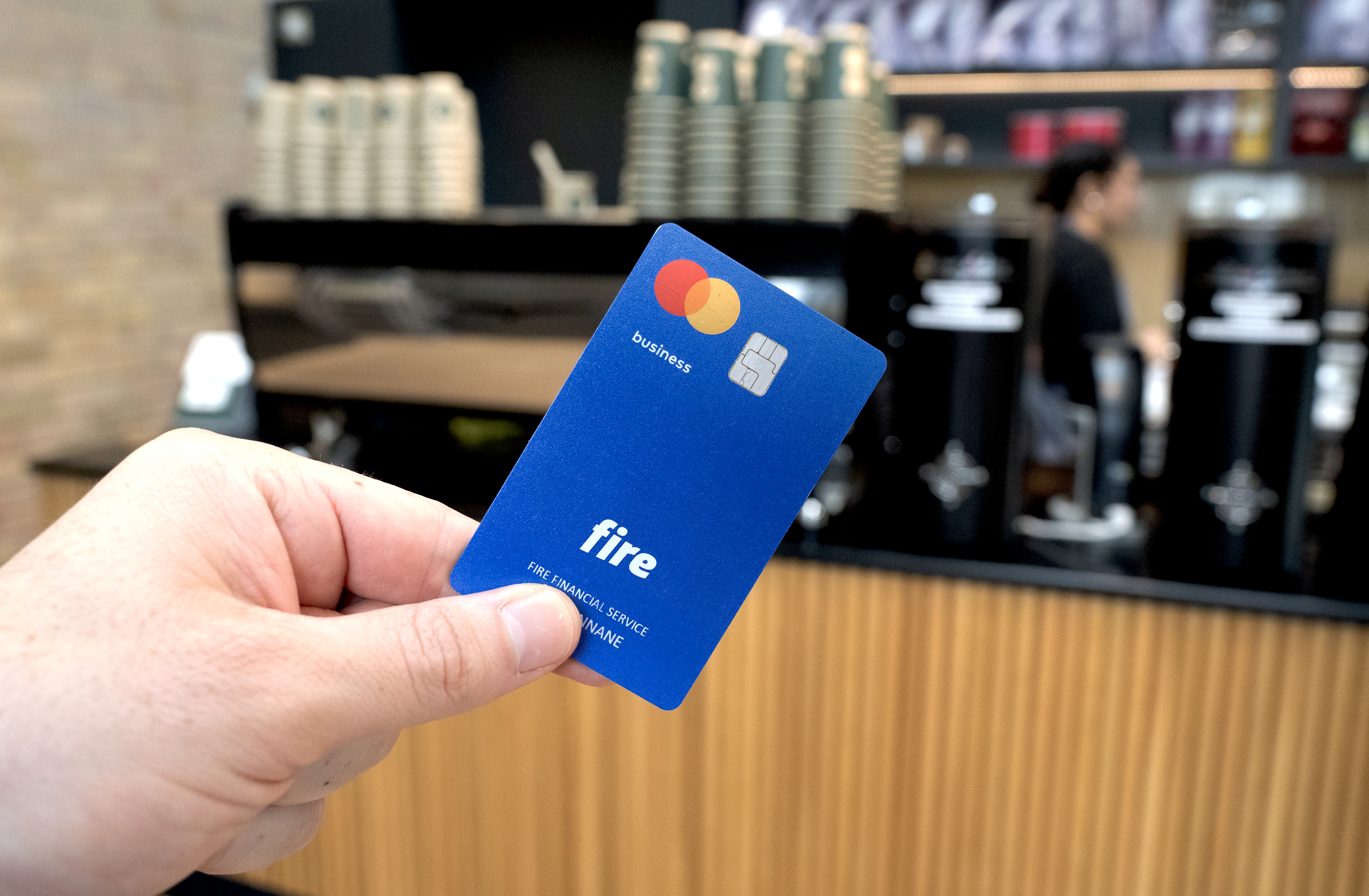 Fire’s business debit card over a coffee shop counter.